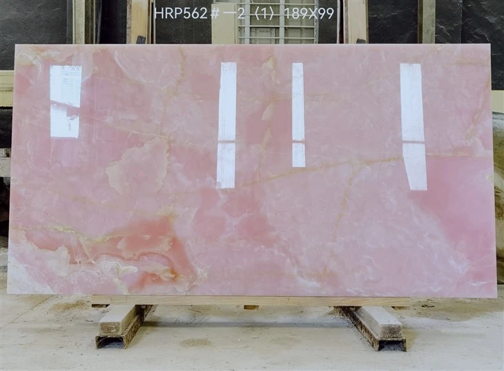 Client-approved Afghan Pink Onyx slab with soft pink clouding, cream-white movement and natural tonal variation.